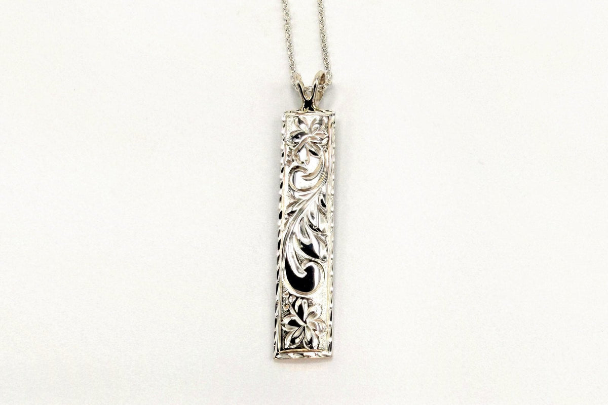 Silver bar pendant engraved with Hawaiian scroll and floral motifs on a fine chain