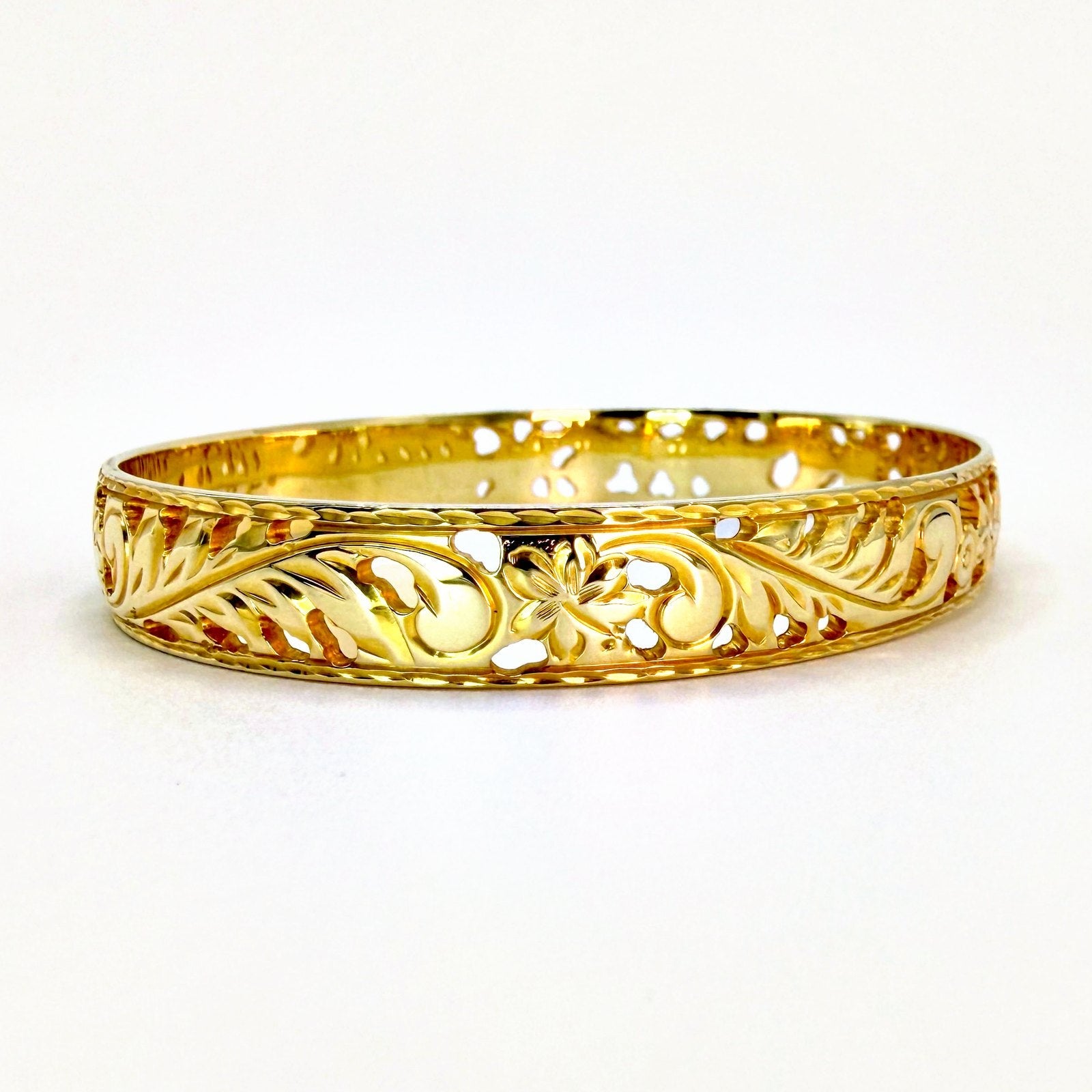 Aloha Pauahi gold Hawaiian heirloom bangle with open hand engraved leaf scrollwork, handcrafted by Jewel Box Hawaii.