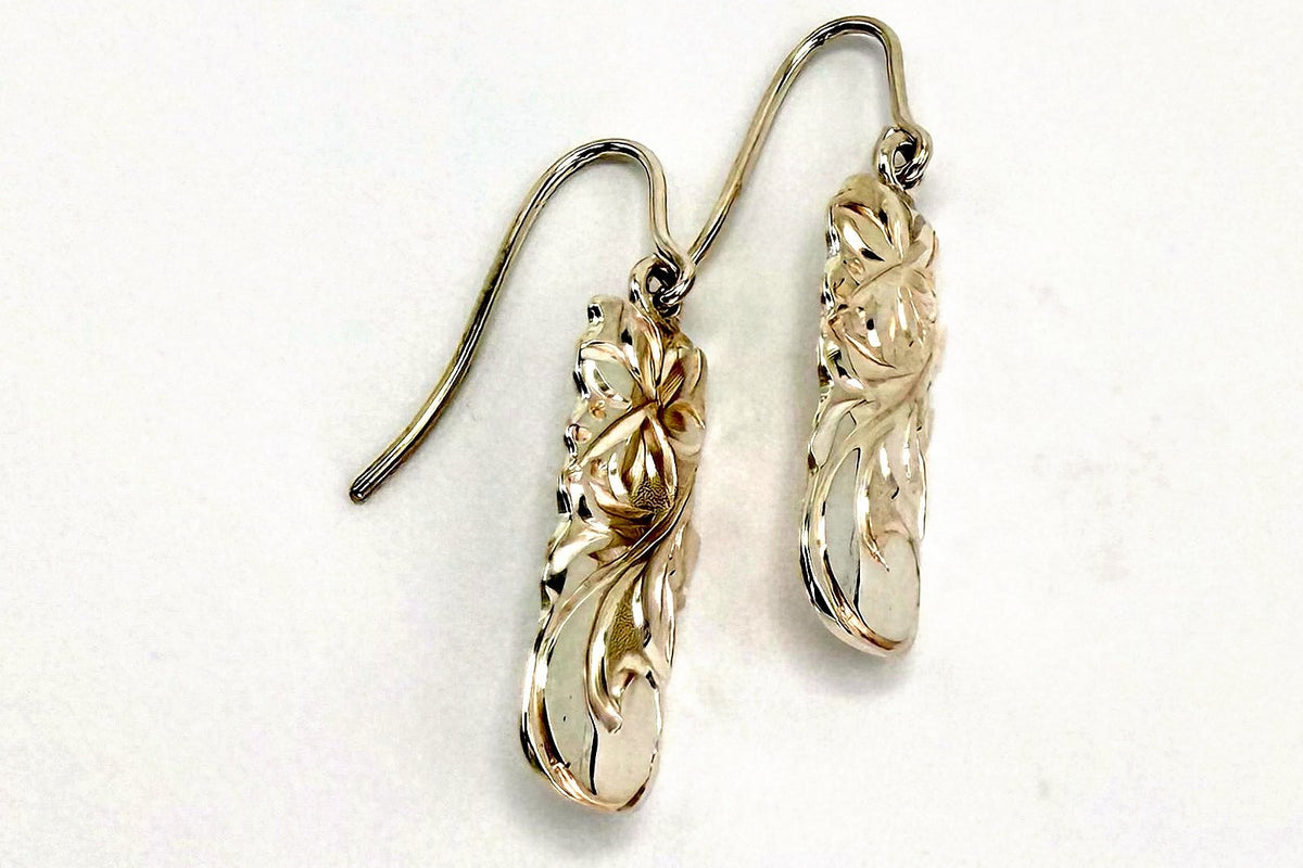 Pair of Hawaiian scroll elongated gold drop earrings with hand engraved floral scroll motif and wire hooks, handcrafted by Jewel Box Hawaii in Honolulu.