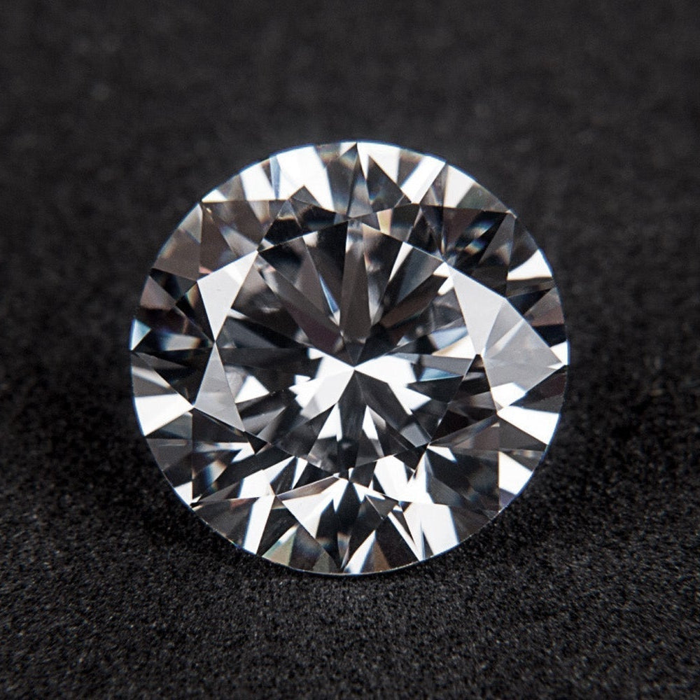 Round brilliant cut diamond on a dark textured surface, April's birthstone
